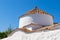 White Greek chapel with red roof.