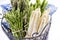 White and green asparagus bundle in a basket