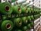 White and green yarns in racks for artificial grass weaving machines.