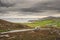 White and grey color camper van moving on road. Travel and holiday on a road trip. Malin head, county Donegal, Ireland. Motor home