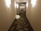 White and grey hallway with lights and white trash bags