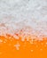 White ground salt on an orange background.