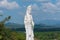 White Guanyin statue on surrounded by the mountains