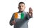 White guy holding a flag of Cote d`Ivoire and with a serious face shows a hand stop sign isolated on a white background