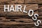 White Hair Loss Text On Wood