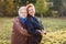 The white haired elderly mother hugs adult daughter