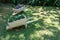 White hand cart serving as a vessel for plants adorning a residential garden.