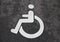 White Handicap Disabled Sign on Black Asphalt