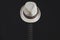 White hat hangs on the guitar fretboard. acoustic musical instrument. strings on the guitar neck