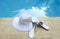 White hat shoes sunglasses pool blue water