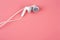 White headphone over pink color background