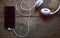 White headphones on wooden background connected to a cell phone