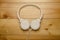 White headphones on wooden table. Modern headphone with cable