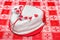 White heart shape cake with red hearts ribbon
