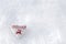 White heart with winter cross stitch deer in red on snow. Scandinavian Norwegian styled Christmas stitching on snowflakes