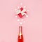 White hearts, bottle of wine and gift box on pink background. Valentines day concept. Flat lay, top view, copy space