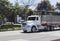 White heavy truck transiting at north highway in sunny midday