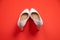 White high heeled shoes on red background - top view concept - heels pigeon toe