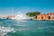 White high-speed motor boat moored along the coast on one of the canals in Venice, Italy