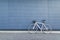 White highway bike stands on the background of a blue wall. Sports concept