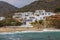 White hillside villas next to a sandy beach