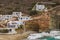 White hillside villas next to a sandy beach