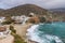 White hillside villas next to a sandy beach