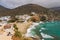 White hillside villas next to a sandy beach