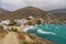 White hillside villas next to a sandy beach