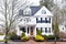 White Historic House with Wood Door and Unique Windows