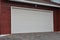 White horizontal garage gate on a red wooden wall