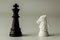 White horse chess and  black king chess stand encounter on a chessboard. - Business winner and fight concept