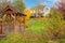 White horse farm American house during fall with green grass.