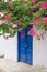 White House With Blue Door and Pink Bougainvillea, Greece