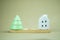 White house and Christmas tree ceramic placed on wood plank for decorative in home