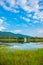 white house near the lake with mountain.