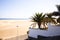 White house with palms near sandy beach and Atlantic ocean in Maspalomas, Gran Canaria