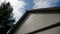 White house wooden roof with black roof with blue sky