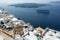 White houses of Fira, Santorini and Nea Kameni volcano in the background