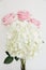 White hydrangea with 3 light pink roses