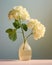 White hydrangea in a vase on a gray background