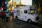 White ice cream truck on a crowded street at night in New York C