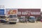 White Indian buses stand in a row at the bus station on the background of billboards and people