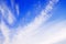 White Ñirrus clouds on light blue sky background closeup, cirrostratus cloud, spindrift clouds, fluffy wispy cloudy skies texture