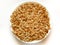 On white isolated background granola on plate, breakfast dish, snack. On the photo is a granule of oatmeal and honey. Application