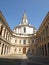 white Italian baroque Church and long courtyard on a sunny day with blke sky 