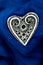 White ivory heart shape on blue woolen textile