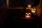 White jack o\'lanterns on a bench at night