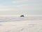 White jeep drifts on snow and ice.