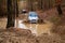 White Jeep Rubicon JK driving through mud.